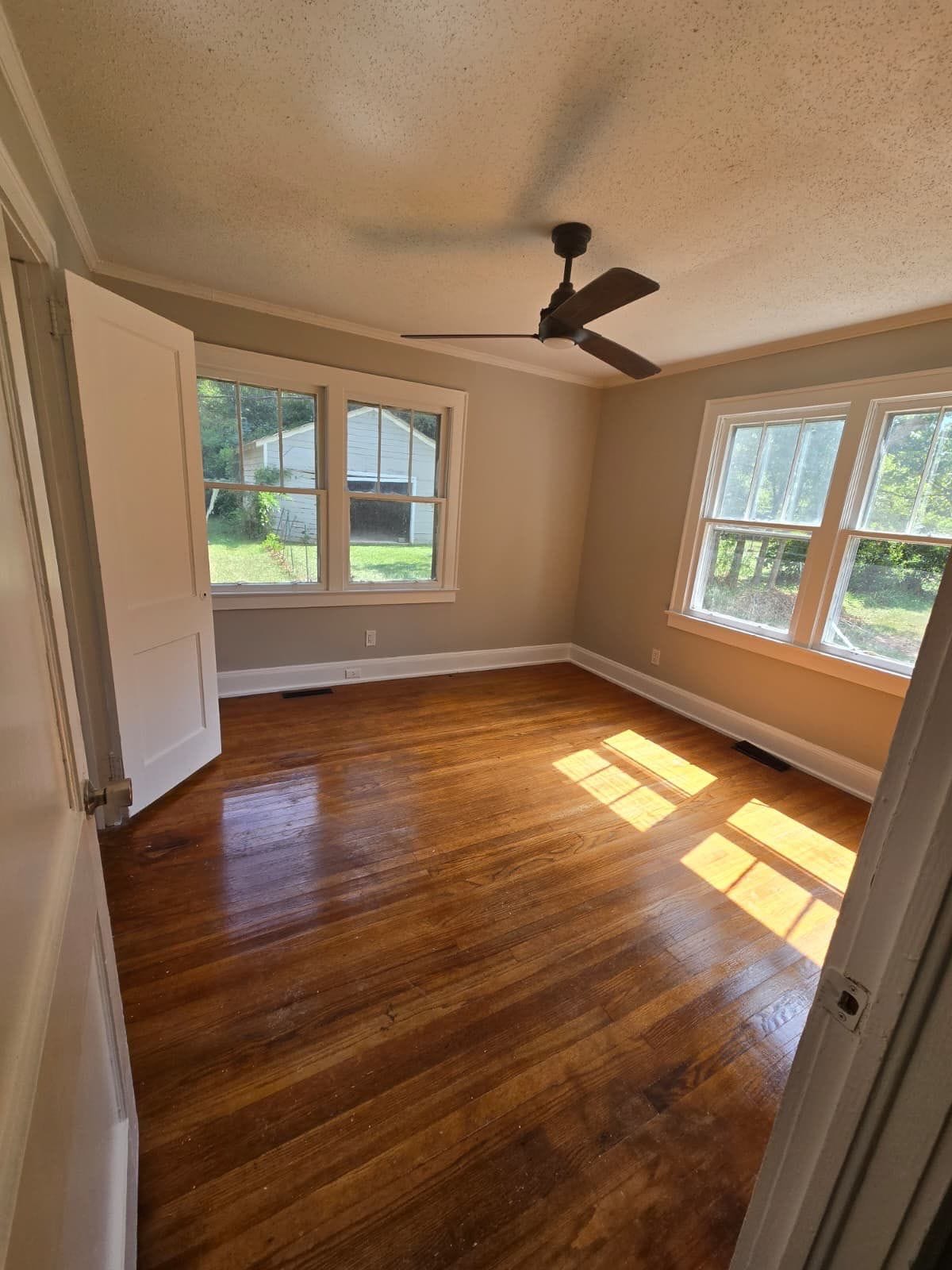 Room with hardwood floors and ceiling fan