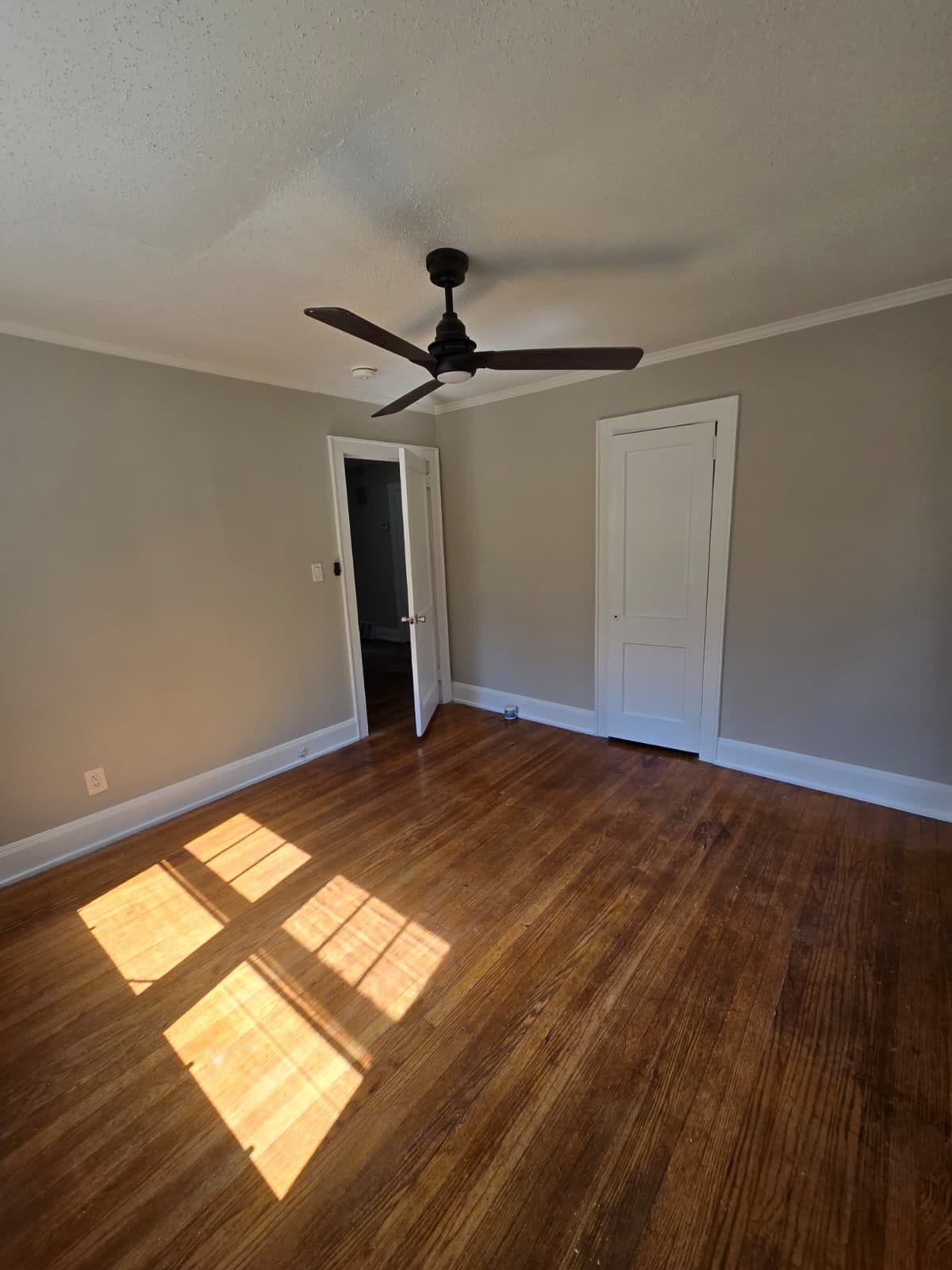 Room with hardwood floors and ceiling fan