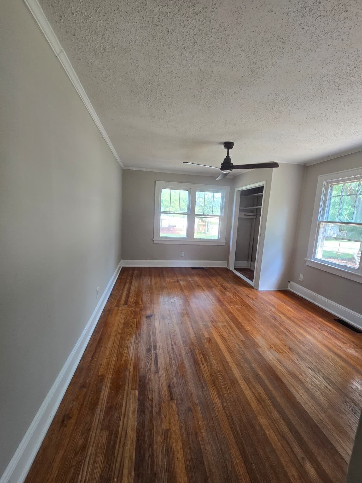 Room with hardwood floors and ceiling fan