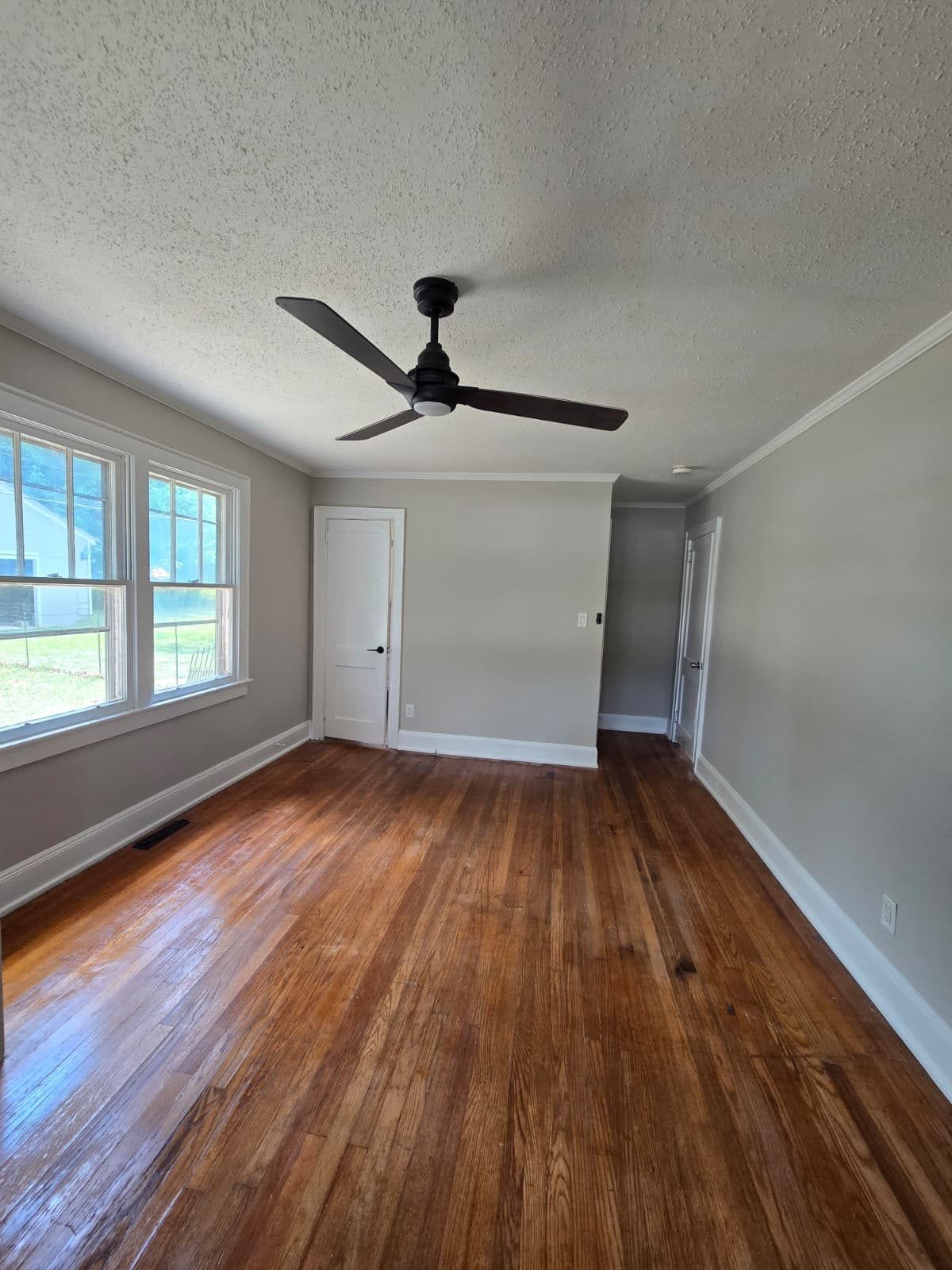 Room with hardwood floors and ceiling fan
