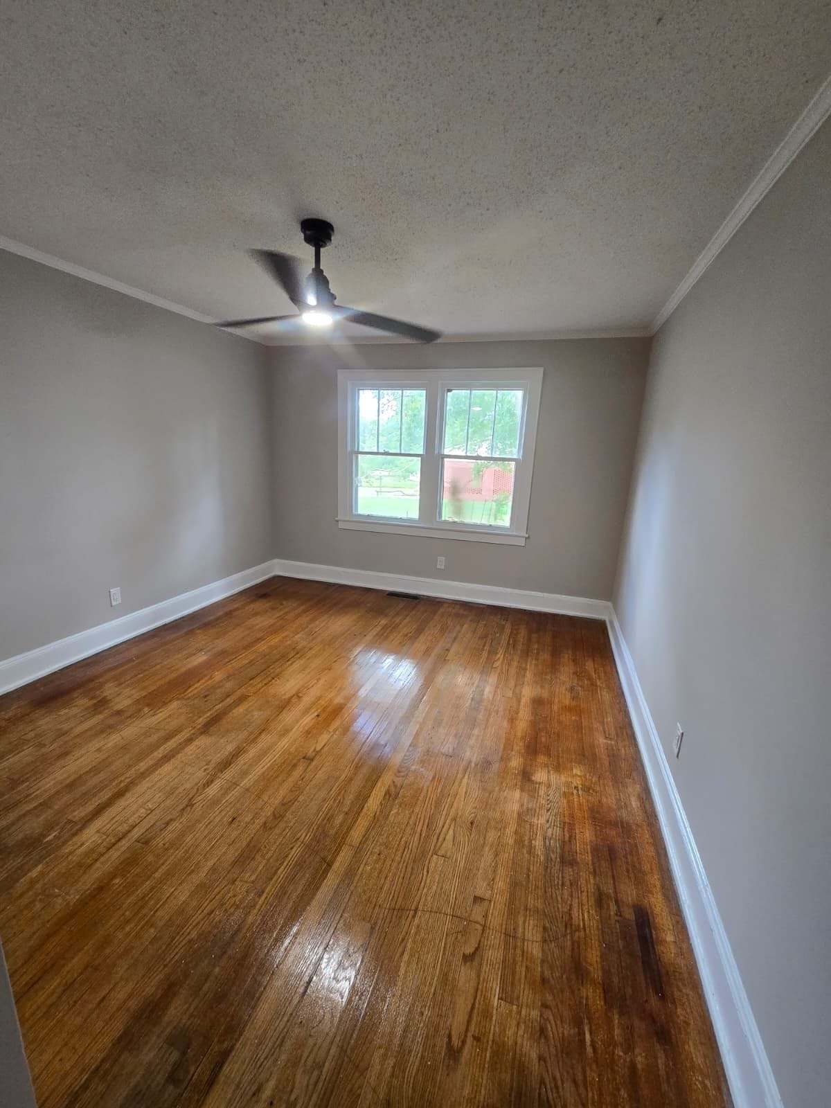 Room with hardwood floors and ceiling fan