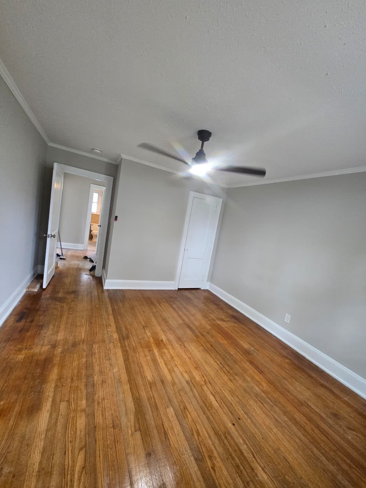 Room with hardwood floors and ceiling fan