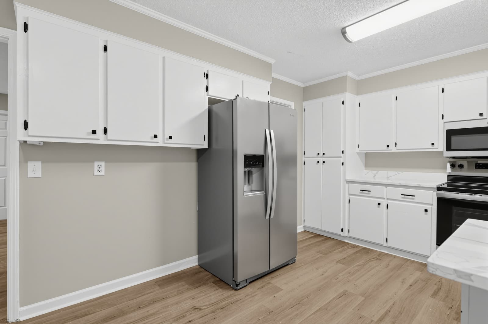 Kitchen with stainless refrigerator